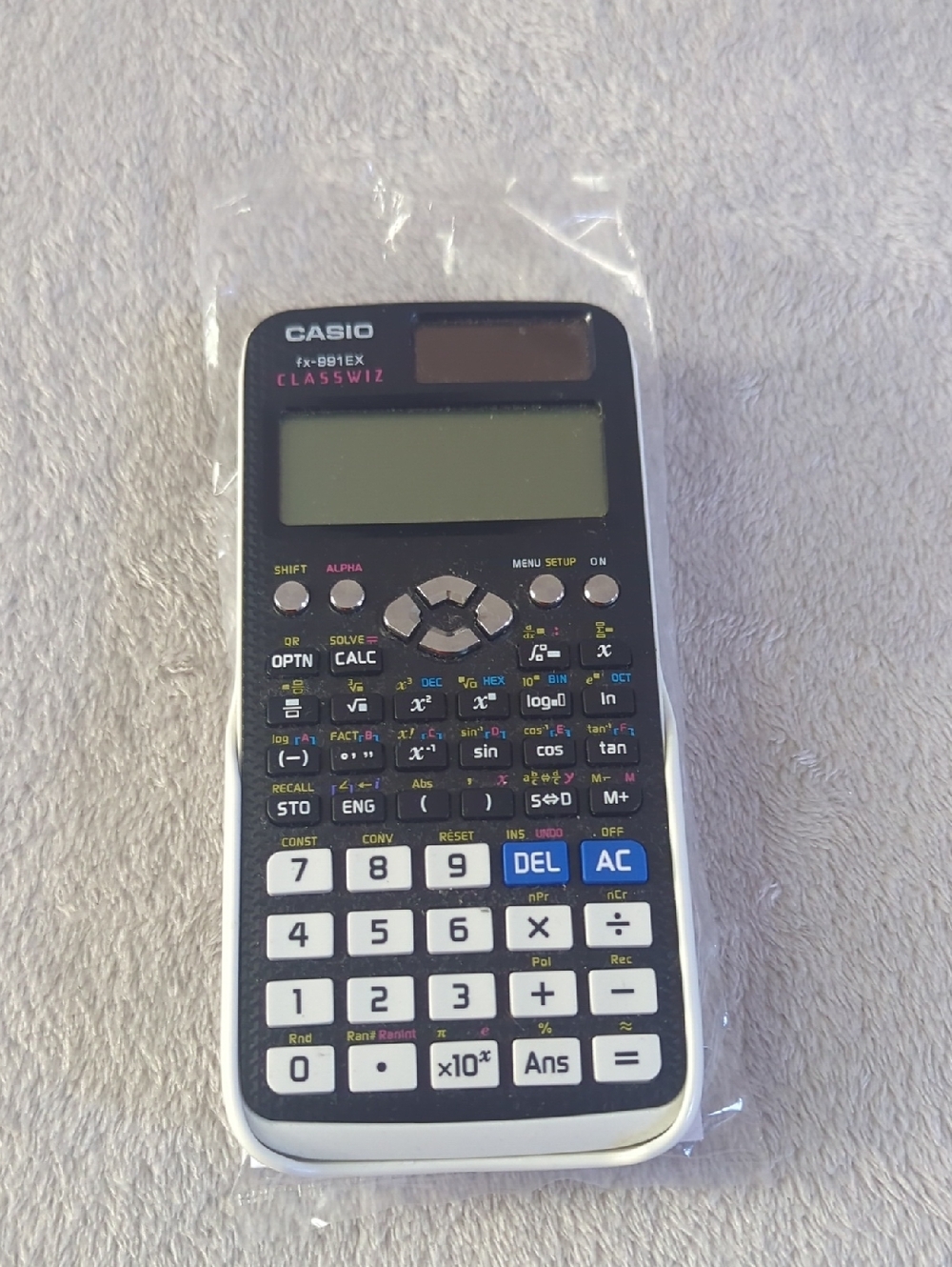 Casio scientific calculator in black and white with blue accents w/ directions.